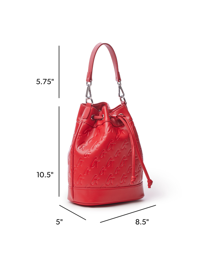 Red medium monogram bucket bag with adjustable strap and drawstring closure, featuring embossed logo design.