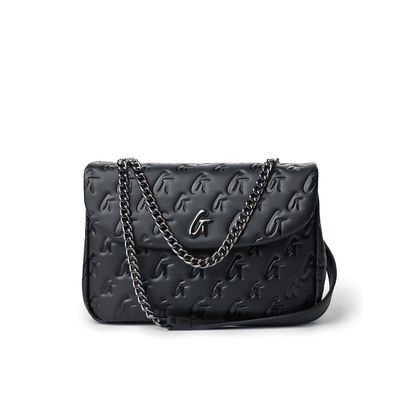 Black medium monogram flap bag with embossed logo pattern and a silver chain strap.