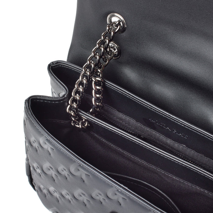 Close-up of a black medium monogram flap bag with a chain strap, showing interior compartments and embossed logo.
