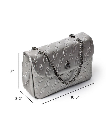 Medium monogram flap bag in platinum with a chain strap, featuring embossed logo design and elegant silhouette.