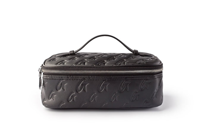 Medium black monogram toiletry bag with embossed logo pattern, zipper closure, and top handle for travel use.