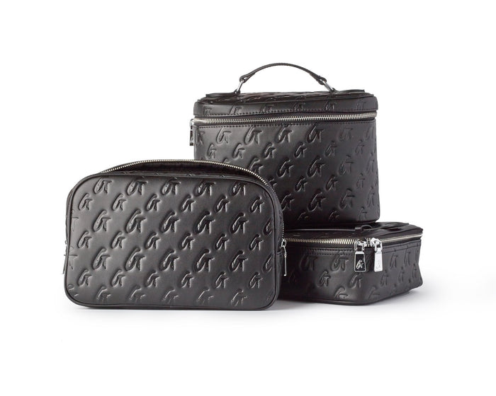Set of black monogram toiletry bags in various sizes with embossed logo pattern and silver zippers.