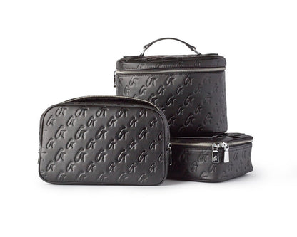 Set of black monogram toiletry bags in various sizes with embossed logo pattern and silver zippers.