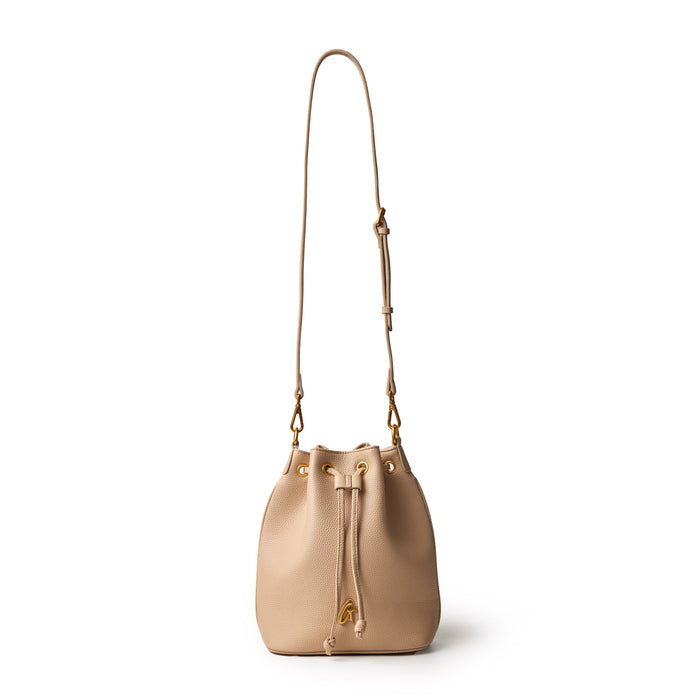 Medium pebble bucket bag in nude color with a drawstring closure and adjustable shoulder strap, featuring gold-tone hardware.