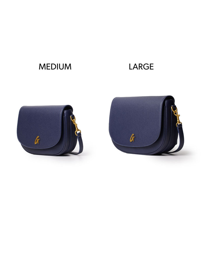 Navy medium pebble shoulder bag with a sleek design and gold hardware, perfect for stylish everyday use.