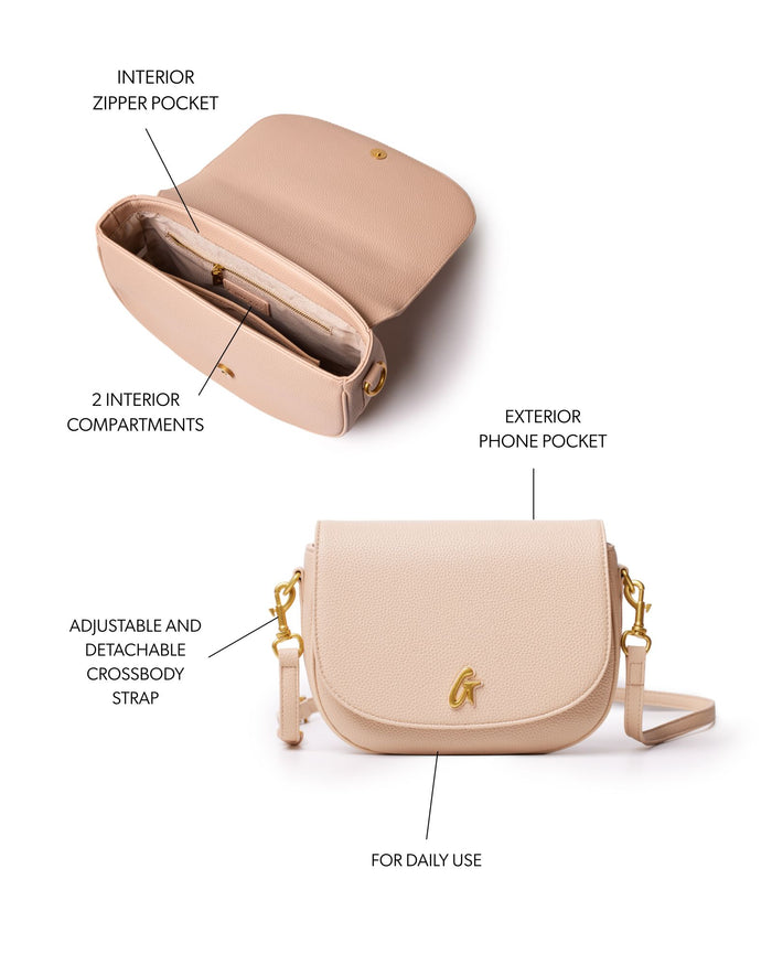 Medium pebble shoulder bag in nude with adjustable crossbody strap, exterior phone pocket, and multiple interior compartments.