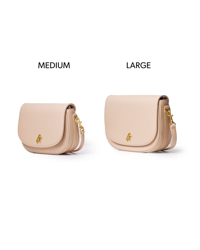Medium pebble shoulder bag in nude with a sleek design and gold accents, perfect for stylish everyday use.