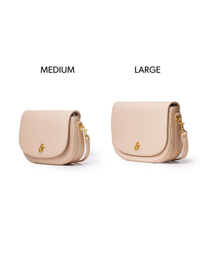 Medium pebble shoulder bag in nude with a sleek design and gold accents, perfect for stylish everyday use.