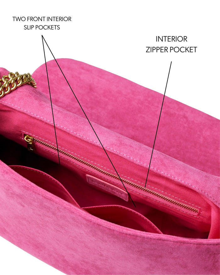 Hot pink medium suede flap bag featuring two front slip pockets and an interior zipper pocket for organized storage.