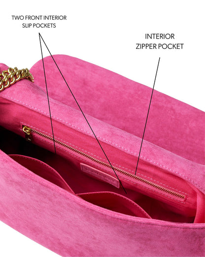 Hot pink medium suede flap bag featuring two front slip pockets and an interior zipper pocket for organized storage.