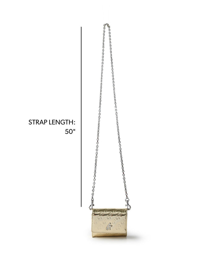 Metallic gold compact WOC handbag with a stylish monogram design and a 50-inch chain strap for versatile wear.