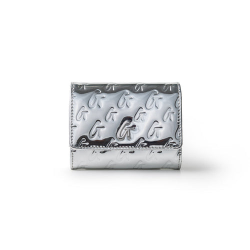 Metallic silver compact wallet with embossed G logo pattern and a flap closure, featuring a sleek, shiny finish.