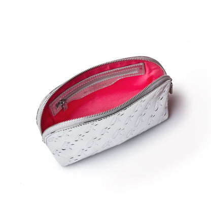 Metallic silver cosmetic pouch with embossed monogram pattern, pink interior, and zip closure.