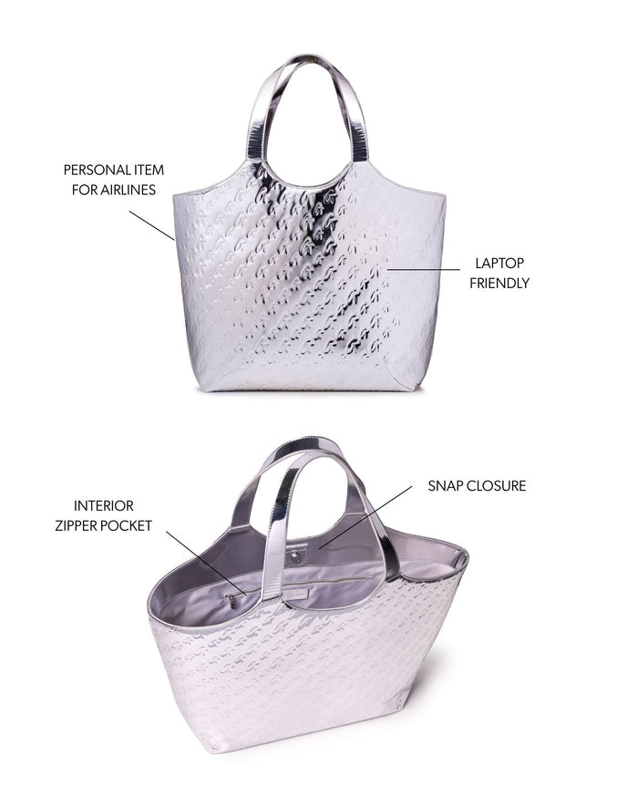 Metallic silver maxi tote with monogram design, featuring a snap closure and interior zipper pocket, ideal for laptops.