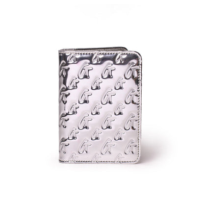 Metallic silver passport holder with embossed monogram G pattern, stylish and sleek travel accessory.