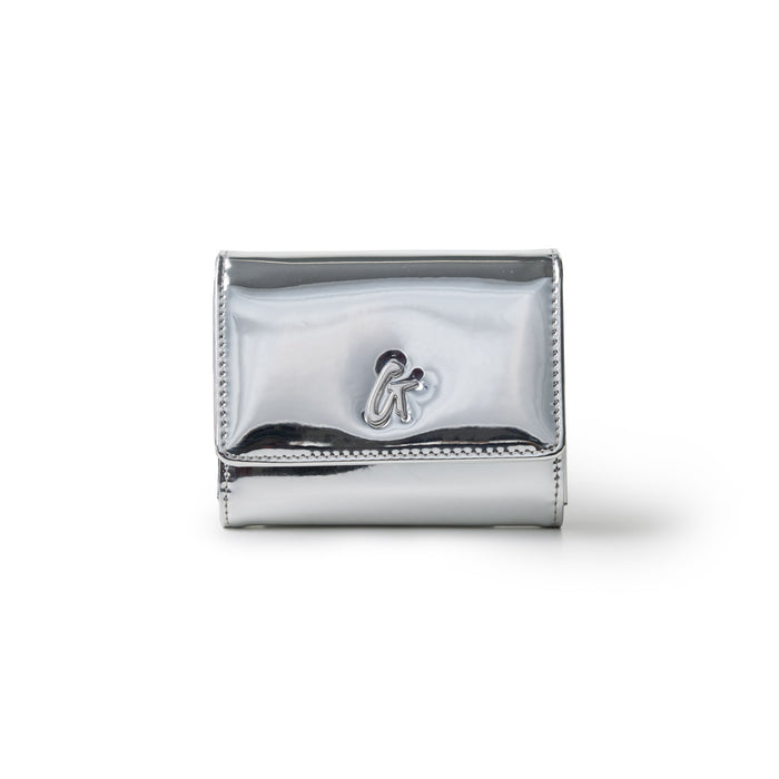Metallic silver compact wallet with a shiny finish and a small logo emblem on the front.
