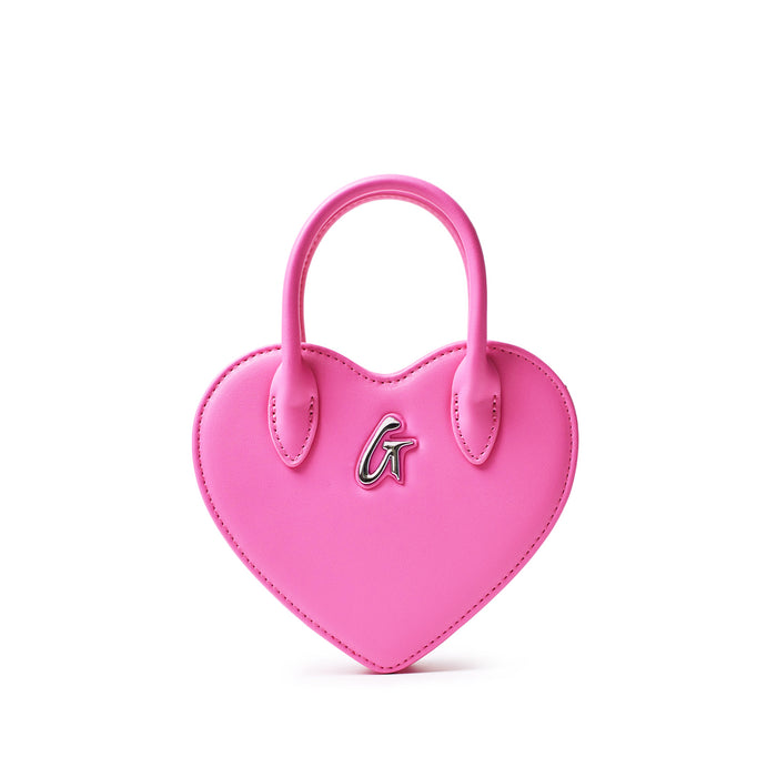Mini pink heart-shaped bag with a silver "G" logo, featuring a top handle and stitched edges, stylish and cute accessory.