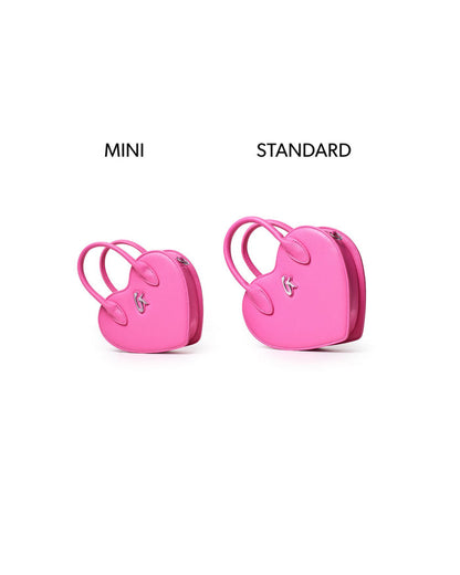 Mini heart-shaped pink handbag displayed alongside a standard size for comparison, showcasing its stylish design.