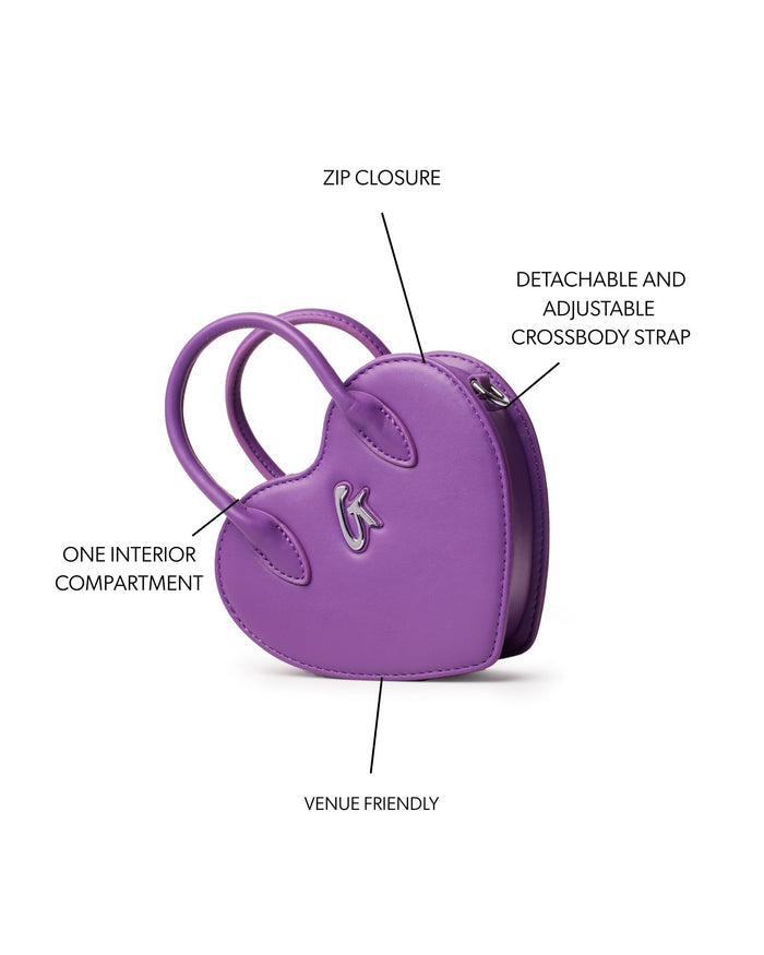 Mini heart bag in purple with zip closure, one interior compartment, and detachable adjustable crossbody strap.