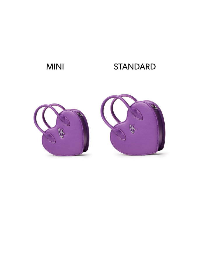 Mini heart-shaped handbag in purple, showcasing its compact size alongside a standard version for comparison.