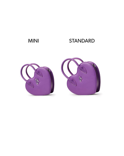 Mini heart-shaped handbag in purple, showcasing its compact size alongside a standard version for comparison.