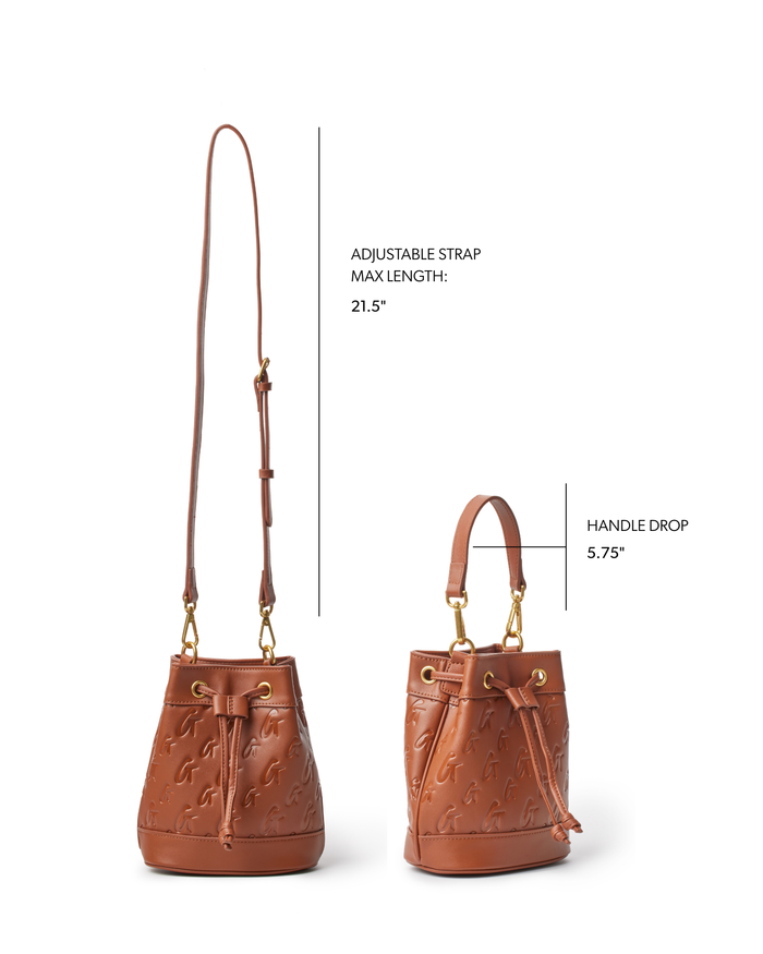 Mini monogram bucket bag in brown with adjustable strap and handle drop, featuring embossed logo design.