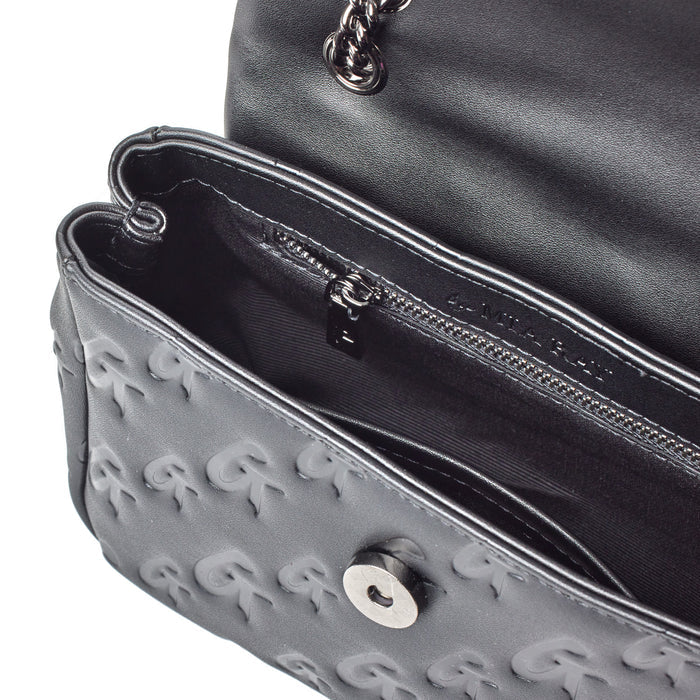 Black mini Monogram Flap Bag with embossed G logo pattern, chain strap, and interior zip pocket.
