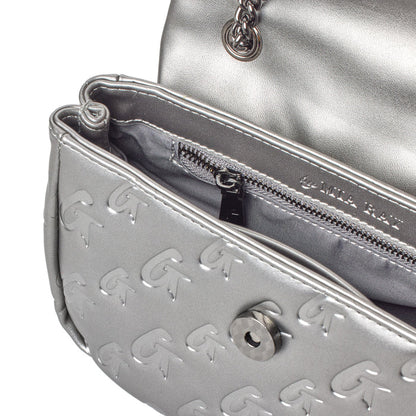 Close-up of a silver MINI Monogram Flap Bag in platinum, featuring embossed logo pattern, interior zip pocket, and chain strap.