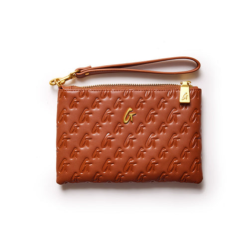 Brown mini monogram gold wristlet with embossed G pattern, gold logo, zipper closure, and wrist strap on white background.