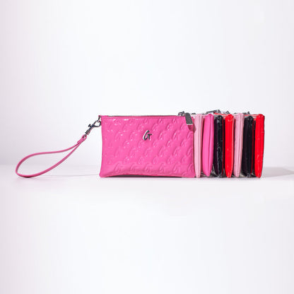 Mini Monogram silver wristlet in mirror hot pink with embossed monogram pattern, attached wrist strap, and multiple color options.