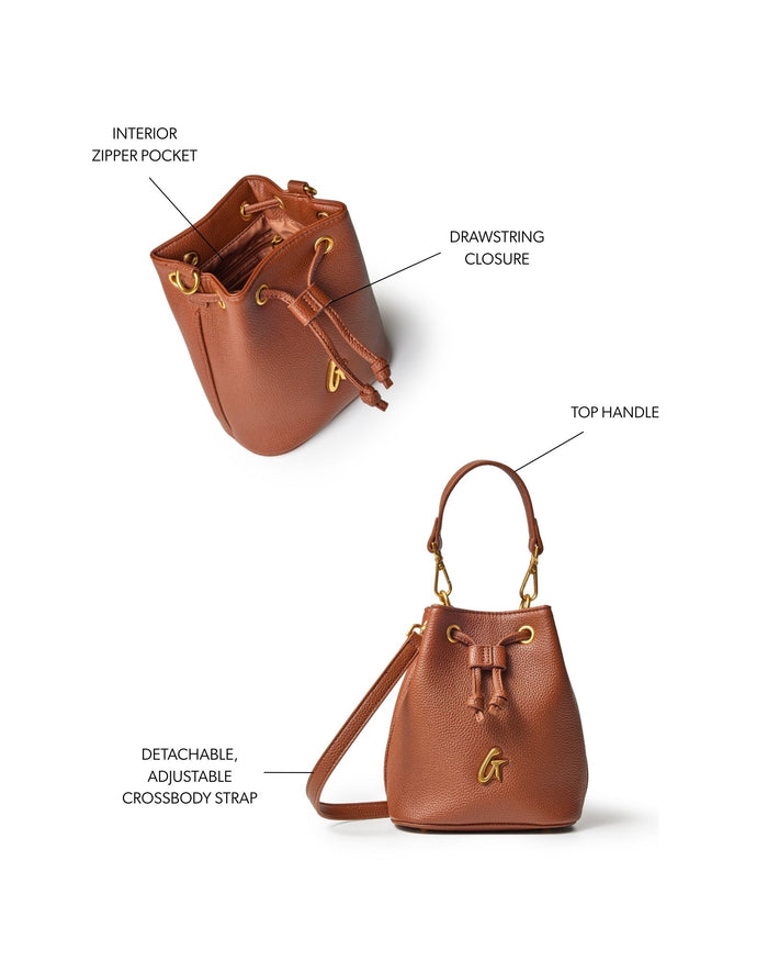 Brown mini pebble bucket bag featuring a drawstring closure, top handle, and detachable adjustable crossbody strap.