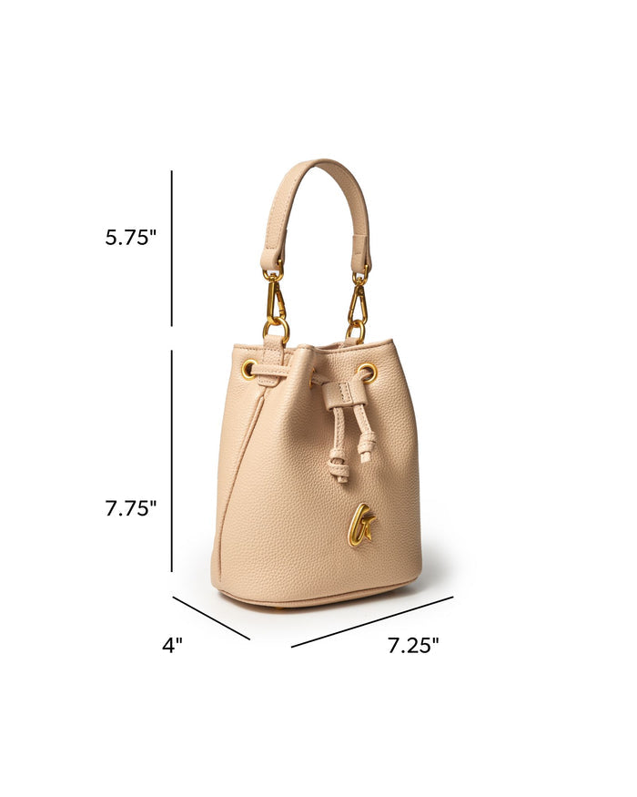 Nude mini pebble bucket bag with gold accents, featuring a drawstring closure and a stylish handle.