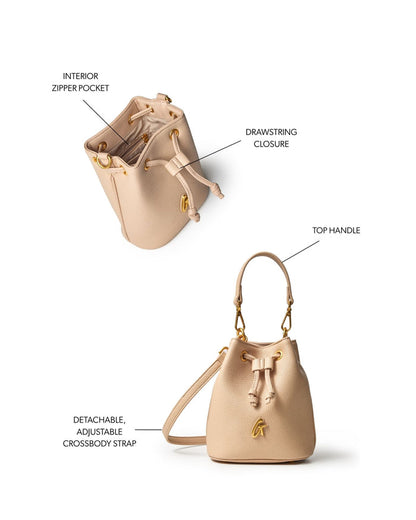 Nude mini pebble bucket bag featuring a drawstring closure, top handle, and detachable adjustable crossbody strap.