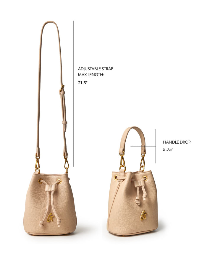 Nude mini pebble bucket bag with adjustable strap and handle drop, showcasing a stylish and versatile design.