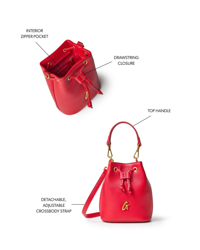 Red mini pebble bucket bag featuring a drawstring closure, top handle, and detachable adjustable crossbody strap.
