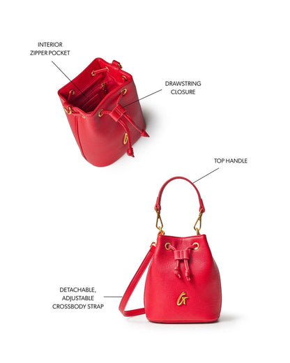 Red mini pebble bucket bag featuring a drawstring closure, top handle, and detachable adjustable crossbody strap.
