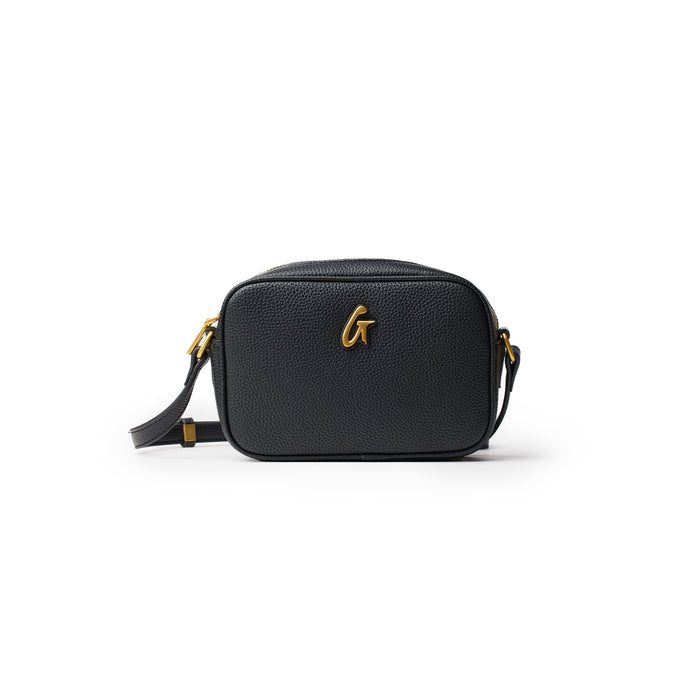 Black mini pebble camera bag with gold hardware and a detachable strap, designed for compact camera storage.