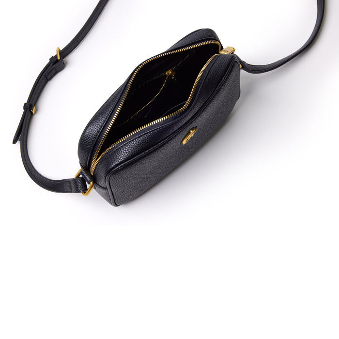 Black mini pebble camera bag with gold zipper and adjustable strap, open to reveal interior compartments.