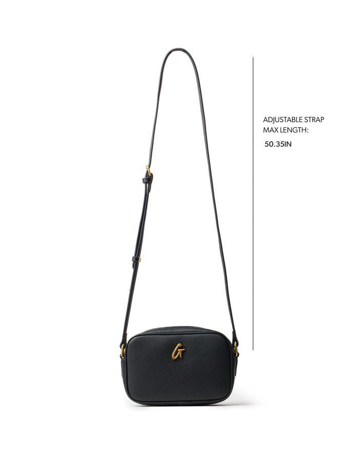 Mini pebble camera bag in black with an adjustable strap, featuring a gold logo accent and textured finish.