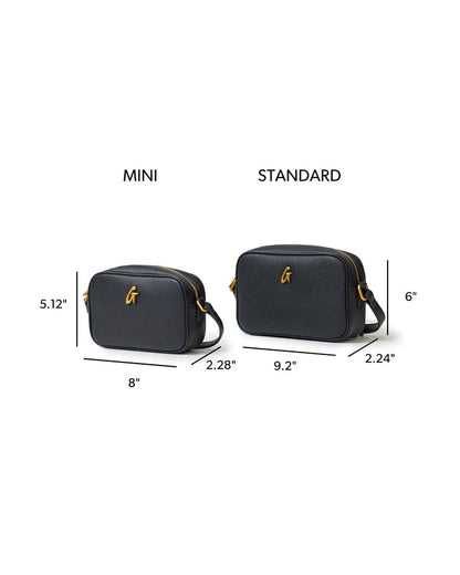 Mini Pebble Camera Bag in black with gold logo, featuring dimensions for mini and standard sizes for comparison.