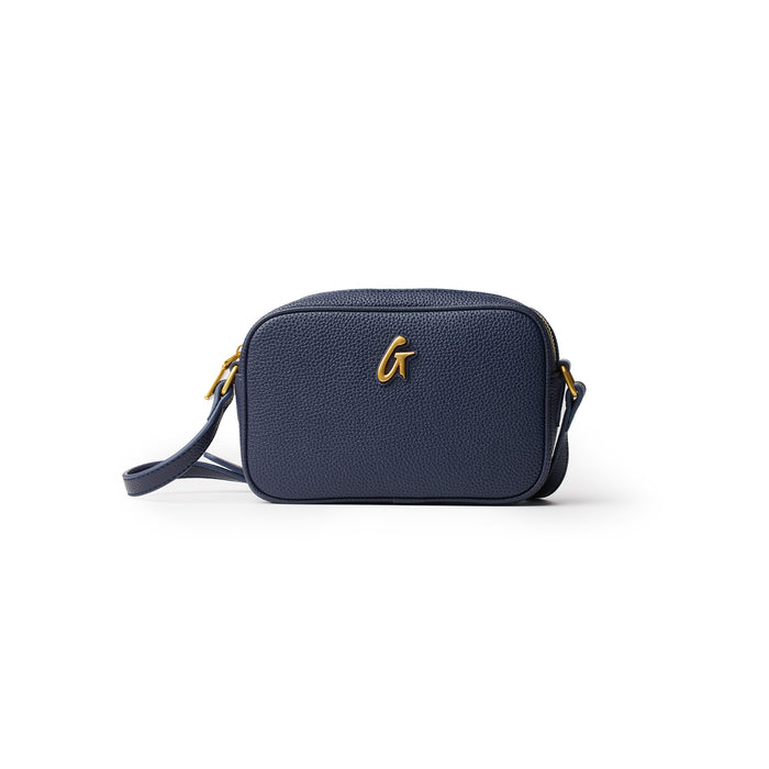 Mini Pebble Camera Bag in navy with gold hardware, compact design, and adjustable strap for stylish carrying.