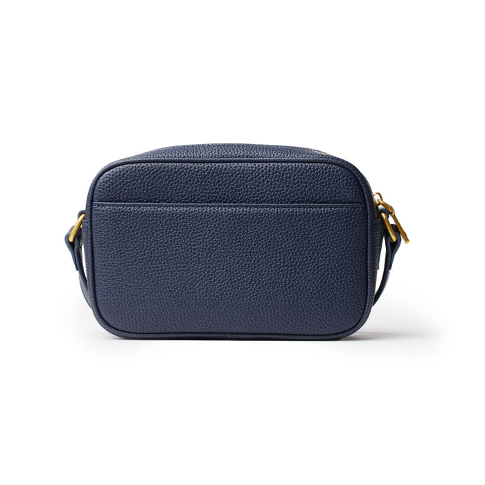 Mini Pebble Camera Bag in navy blue with textured leather, gold hardware, and adjustable strap. Compact and stylish for photography.