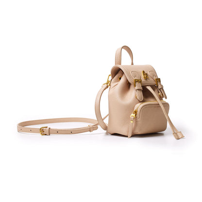 Mini pebble crossbody backpack in nude with gold hardware, adjustable strap, and front zip pocket, stylish and compact.