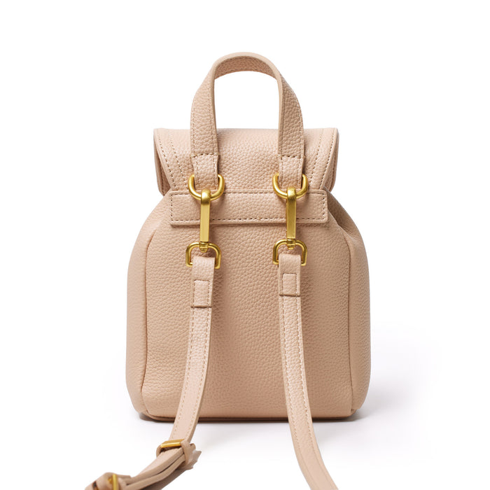 Mini pebble crossbody backpack in nude color with gold hardware, adjustable strap, and textured leather finish.