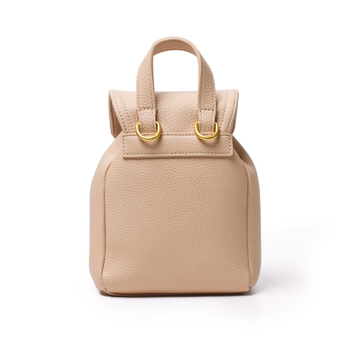 Mini pebble crossbody backpack in nude color with textured leather, gold hardware, and a compact, stylish design.