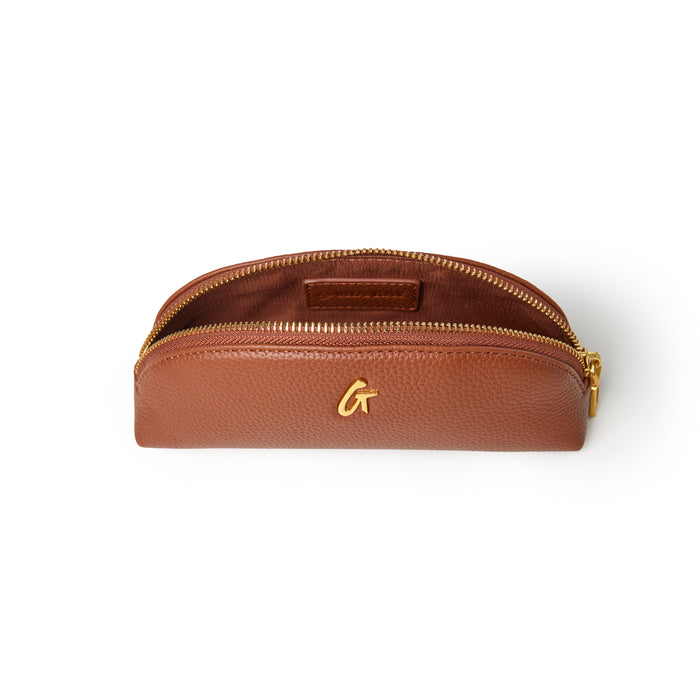 Brown pebble pencil pouch with a gold zipper and logo, perfect for organizing writing tools and accessories.
