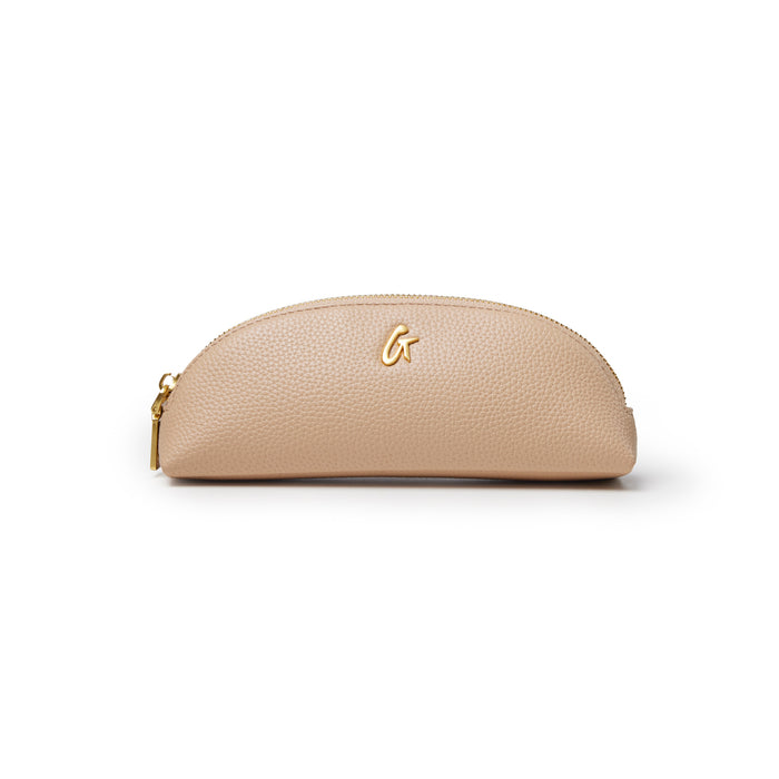 Nude pebble pencil pouch with a gold zipper and logo, perfect for stylish organization of writing tools.