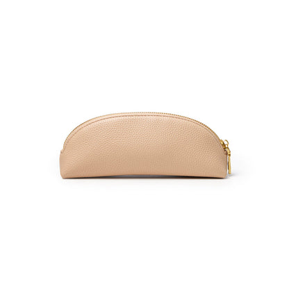 Nude pebble pencil pouch with a curved design and gold zipper, perfect for stylish organization.