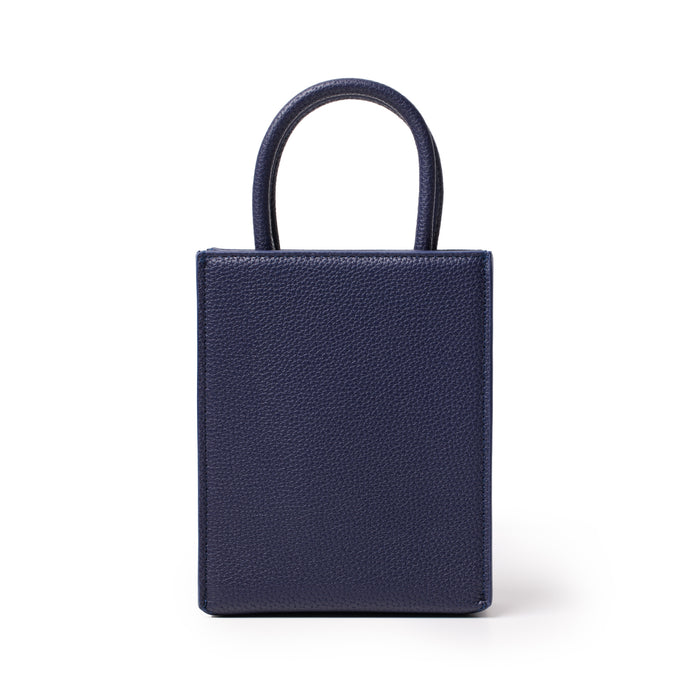 Mini pebble tote bag in navy blue with textured leather finish and top handles, compact and stylish for everyday use.