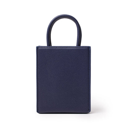 Mini pebble tote bag in navy blue with textured leather finish and top handles, compact and stylish for everyday use.